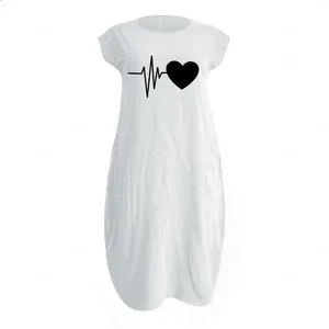 Close-up of heart and heartbeat print on white cotton-linen plus size dress with pockets