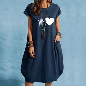 Close-up of heart and heartbeat print on navy cotton linen dress with side pockets