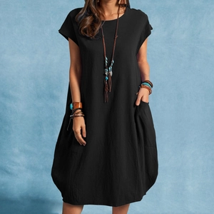 Detail of a casual black cotton-linen dress featuring side pockets and a round neckline