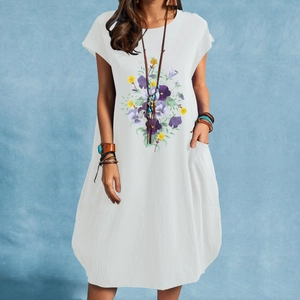 Close-up of white cotton linen dress with floral print and side pockets