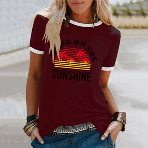 Detail of burgundy ringer tee featuring Sunshine coconut tree print on cotton fabric