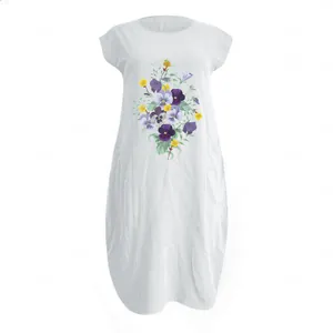 Detail of floral print and side pockets on a white cotton linen summer dress