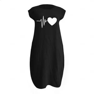 Close-up of heart pulse print and natural linen texture on a black summer dress