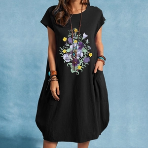 Close-up of floral print and texture on a black cotton linen dress with side pockets