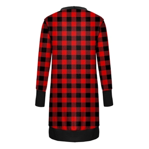 Detail of red and black buffalo plaid fabric on a long sleeve dress with ribbed cuffs