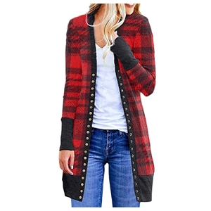 Detail of red buffalo plaid cardigan with metal studs and black ribbed sleeve cuffs