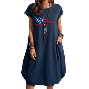 Detail of loose-fit navy cotton-linen dress featuring vintage American flag print and pockets