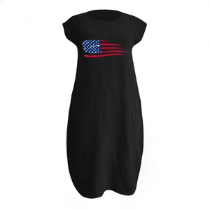 Detail of loose black cotton maxi dress featuring artistic American flag print and pockets