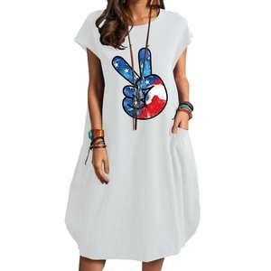 Detail of white cotton linen dress with American flag peace sign print and side pockets