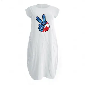 Detail of white cotton linen dress showing round neck and victory sign flag print