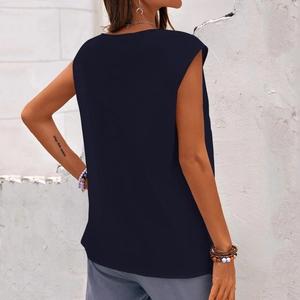Detail view of the back of a dark blue sleeveless top with dandelion print for women