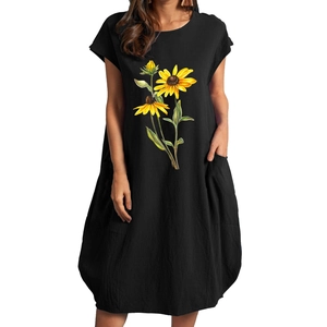 Detail of sunflower print on black cotton linen dress featuring pockets and cocoons style