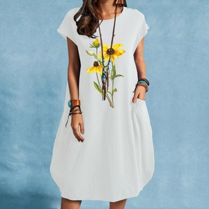 White short-sleeve cotton linen dress with sunflower print and pockets shown on model