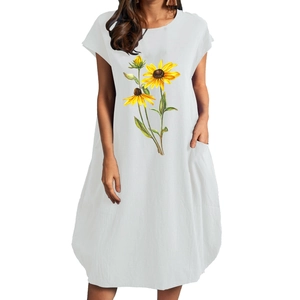 Detailed texture of white cotton linen summer dress with side pockets and sunflower print