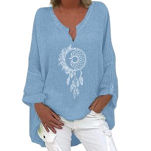 Detail of light blue linen shirt featuring white dreamcatcher and moon print with V-neckline