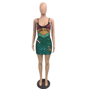 Detail of mermaid sequin dress featuring Love Love text and golden anchor embroidery