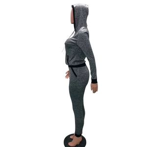 Detail of grey hooded tracksuit featuring black ribbed cuffs and slim-fit texture