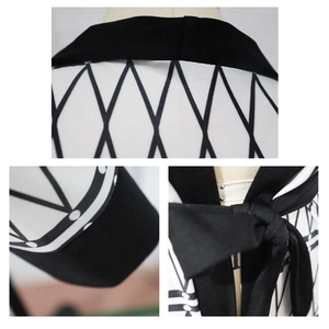 Detail showing geometric diamond pattern stitching and bow tie closure on a cardigan