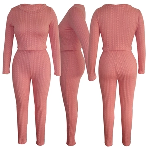 Detailed view of pink cable knit two-piece set featuring cropped top and high waist leggings