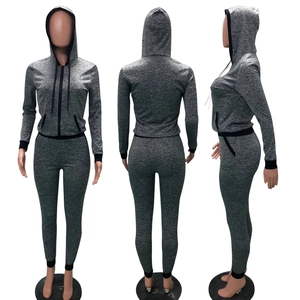 Front, side, and back view of a grey knit zip-up hoodie and slim jogger set for women