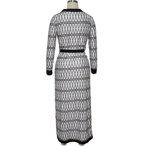 Back view of a long-sleeved dress with geometric patterns and a black waist belt