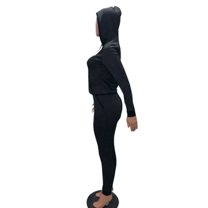 Detail of black two-piece tracksuit featuring a slim fit hoodie and high-stretch leggings