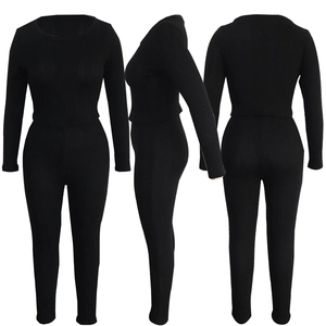 Detail of black rib-knit two-piece set showing elastic fabric texture and slim fit design