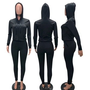 Detail view of charcoal gray two-piece tracksuit with zip hoodie and slim leggings