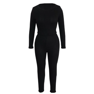 Detailed macro view of the black ribbed knit fabric and texture on women's two-piece set