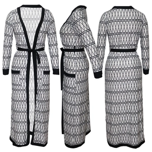 Detail view of black and white geometric diamond pattern on a long cardigan with a waist belt