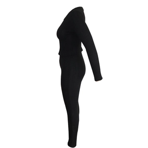 Side view of black ribbed knit two-piece set featuring slim fit top and leggings