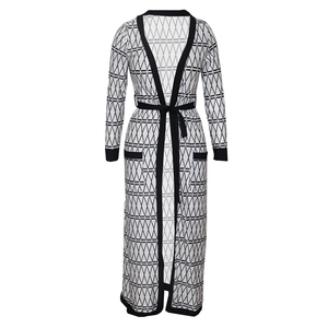 Detail of long geometric print cardigan with black contrast trim and adjustable belt