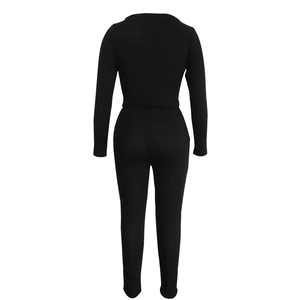 Detail of black ribbed knit texture on long sleeve cropped top and high waist leggings