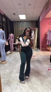 Détail de la veste zippée bicolore et du pantalon évasé à taille haute assorti pour femme