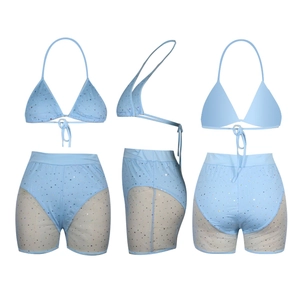 Detail of blue sequined two-piece swimsuit featuring mesh side panels and halter neck bra