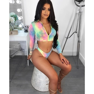 Close-up of tie-dye long sleeve bikini top with yellow front zipper and high cut bottom