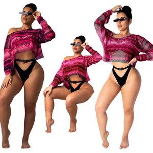 Women's pink snakeskin mesh crop top and black belted bodysuit set on white background