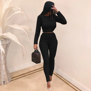 Detailed texture of black knit long-sleeve crop top and high-waisted leggings set