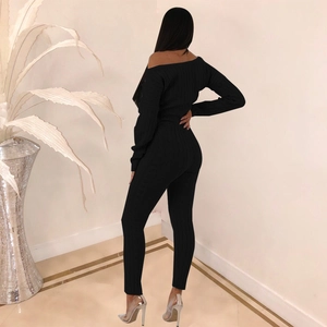 Detail view of black ribbed knit long sleeve two-piece set featuring slim fit bodycon design