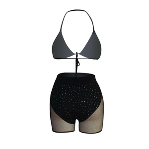 Detailed view of women's sequined bikini top and high-waisted shorts with mesh panels