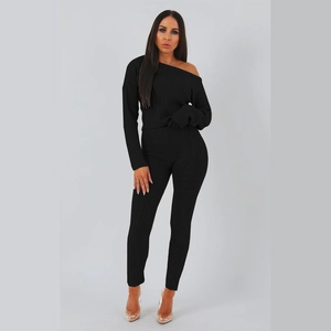 Detail of high-stretch black knit two-piece set showing ribbed texture and off-shoulder cut
