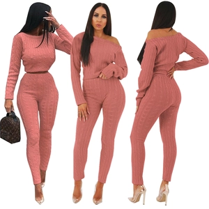 Detail of the pink cable knit texture on the two-piece crop top and high-waist pants set
