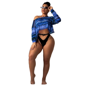 Detail view of snakeskin print crop top and high-cut bottoms with buckle belt strap