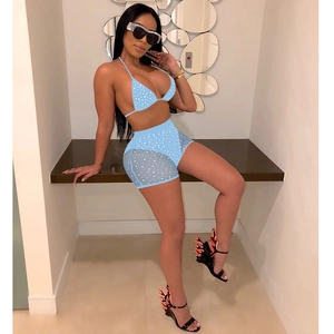Detail of light blue polka dot mesh panels on women's high-waisted two-piece swimsuit set