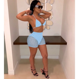Detail of light blue bikini set with sequins and side mesh panels on high-waist shorts