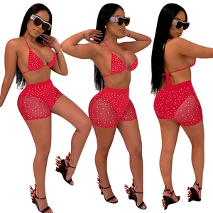 Detail of red polka dot bikini top and high waist mesh shorts for women beachwear