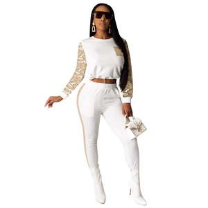 Women's white tracksuit set with gold sequin sleeves and matching drawstring pants