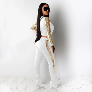 Women's white two-piece sportswear set with golden sequin sleeve and pant side panels