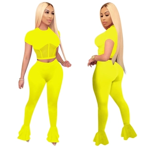 Neon yellow two-piece mesh patchwork sports set with crop top and flared pants