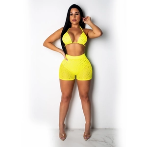 Detail of neon yellow two-piece bikini set with sparkling rhinestones and high waist shorts